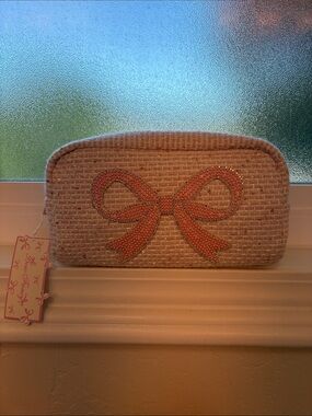 Woven Beige Clutch with Coral Bow Embellishment